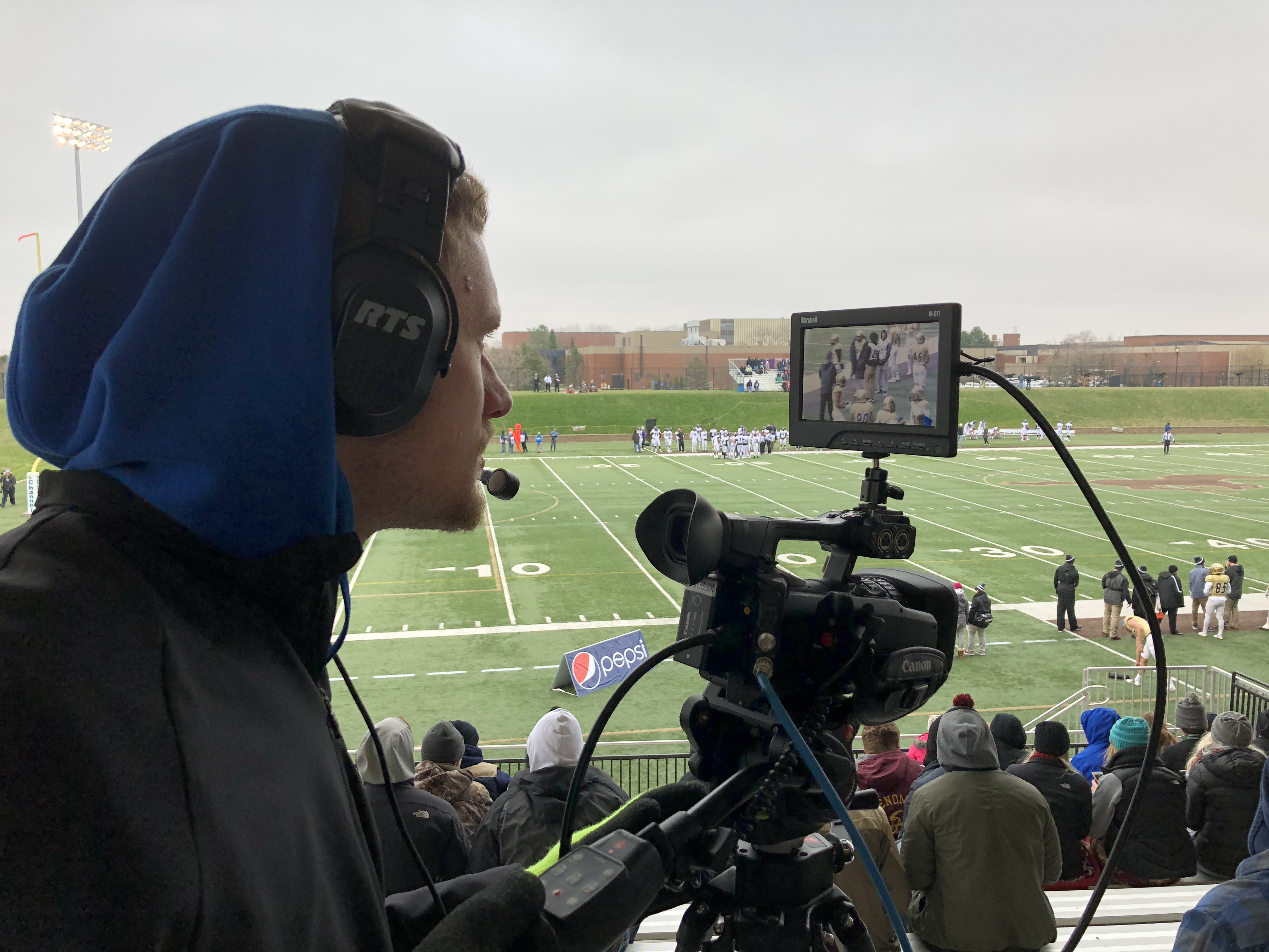 Aaron Bible operates a camera for a Mustang Football broadcast